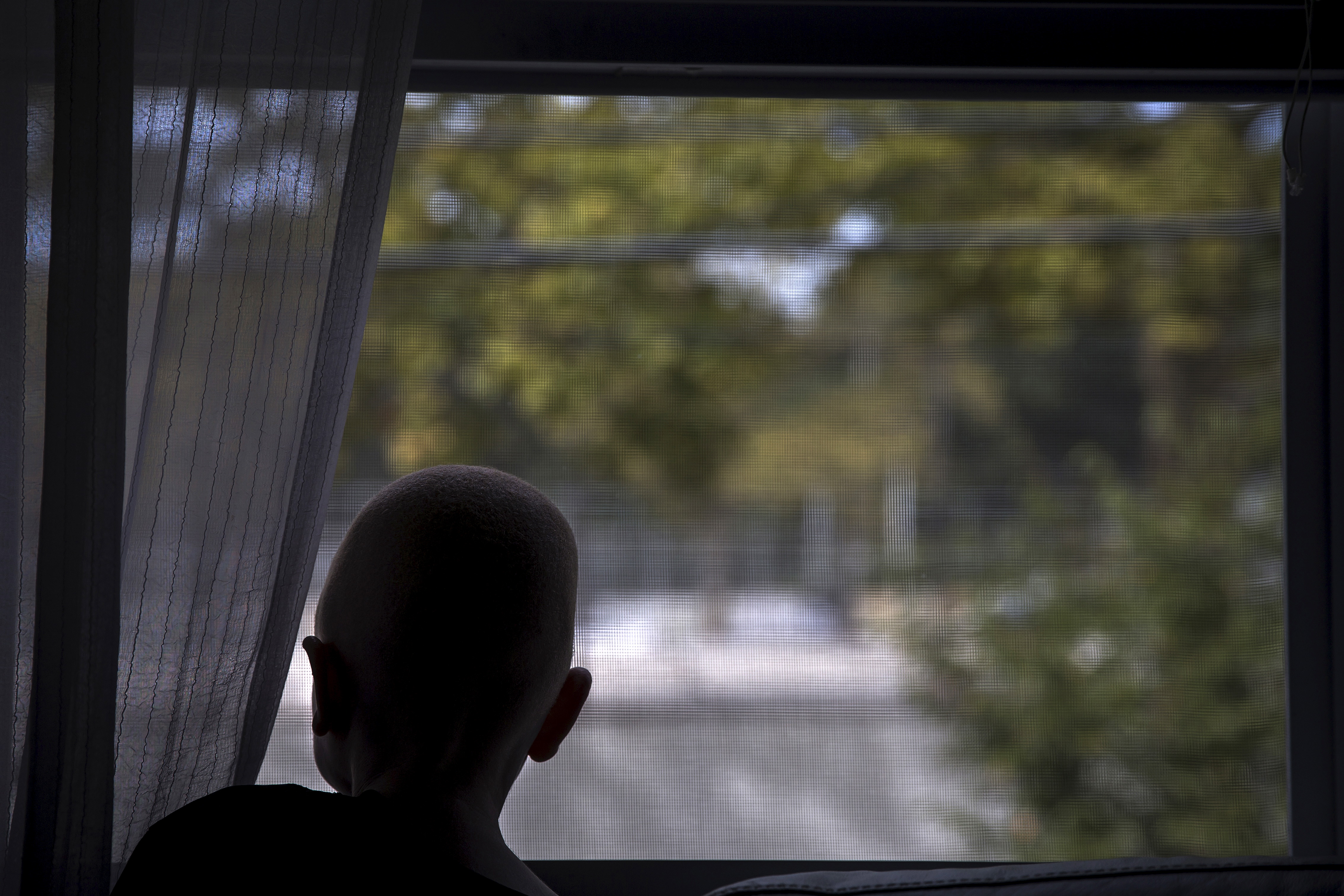 Lusambo from Tanzania looks out the window in the Staten Island borough of New York
