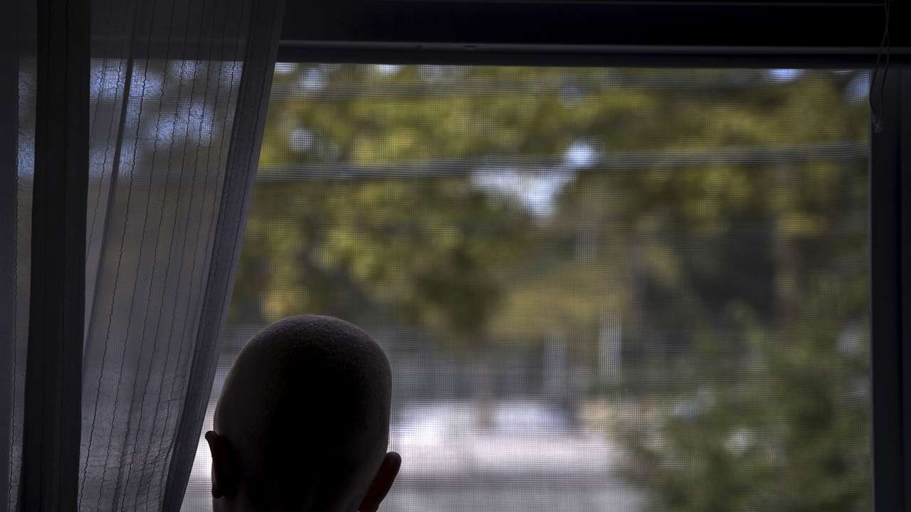 Lusambo from Tanzania looks out the window in the Staten Island borough of New York