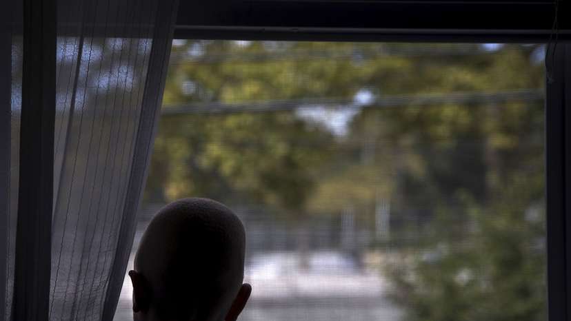 Lusambo from Tanzania looks out the window in the Staten Island borough of New York