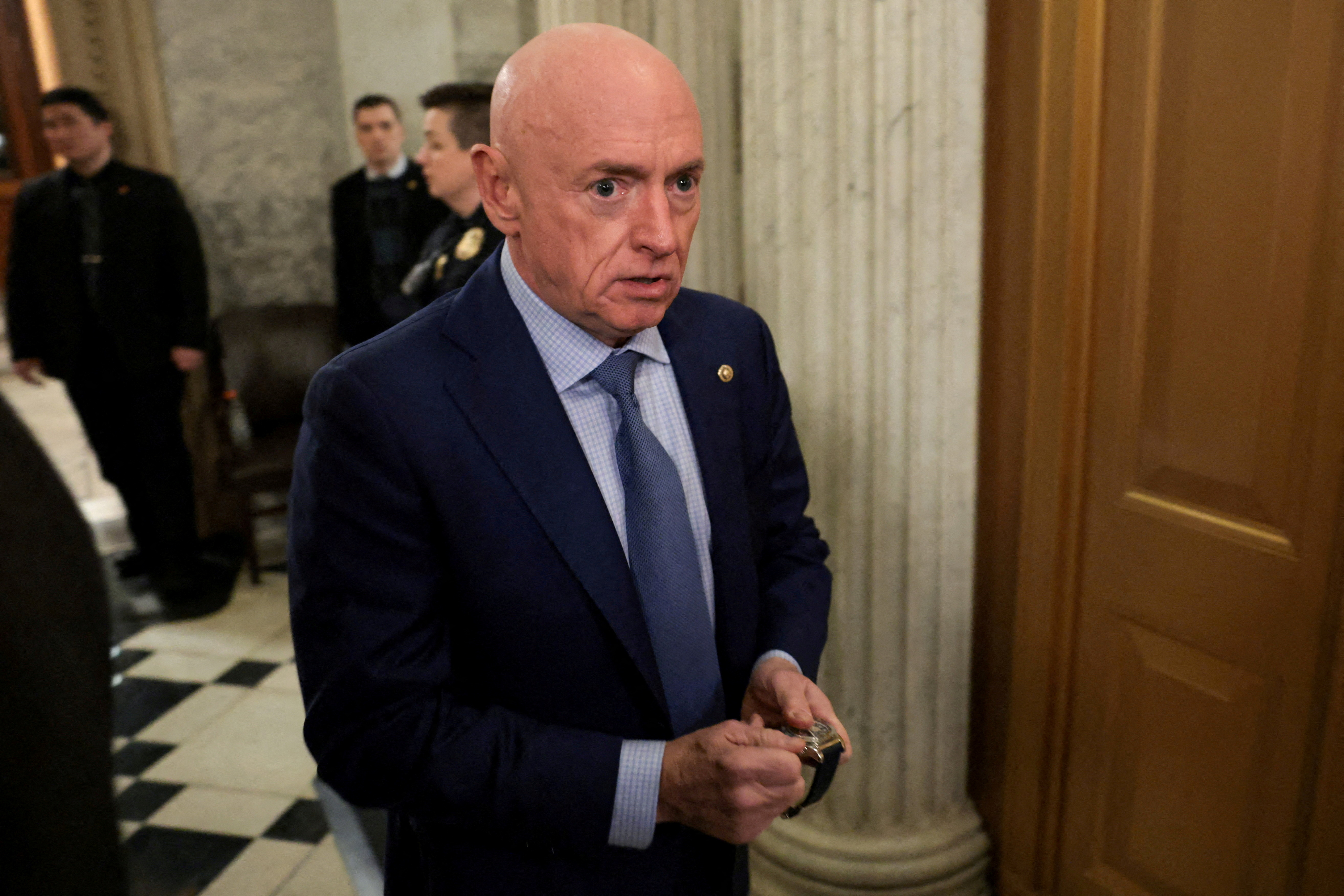 FILE PHOTO: U.S. Senator Kelly departs the Senate floor at U.S. Capitol in Washington
