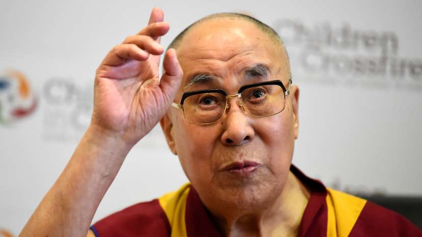Tibetan spiritual leader the Dalai Lama, Patron of Children in Crossfire, gestures during a press conference in Londonderry