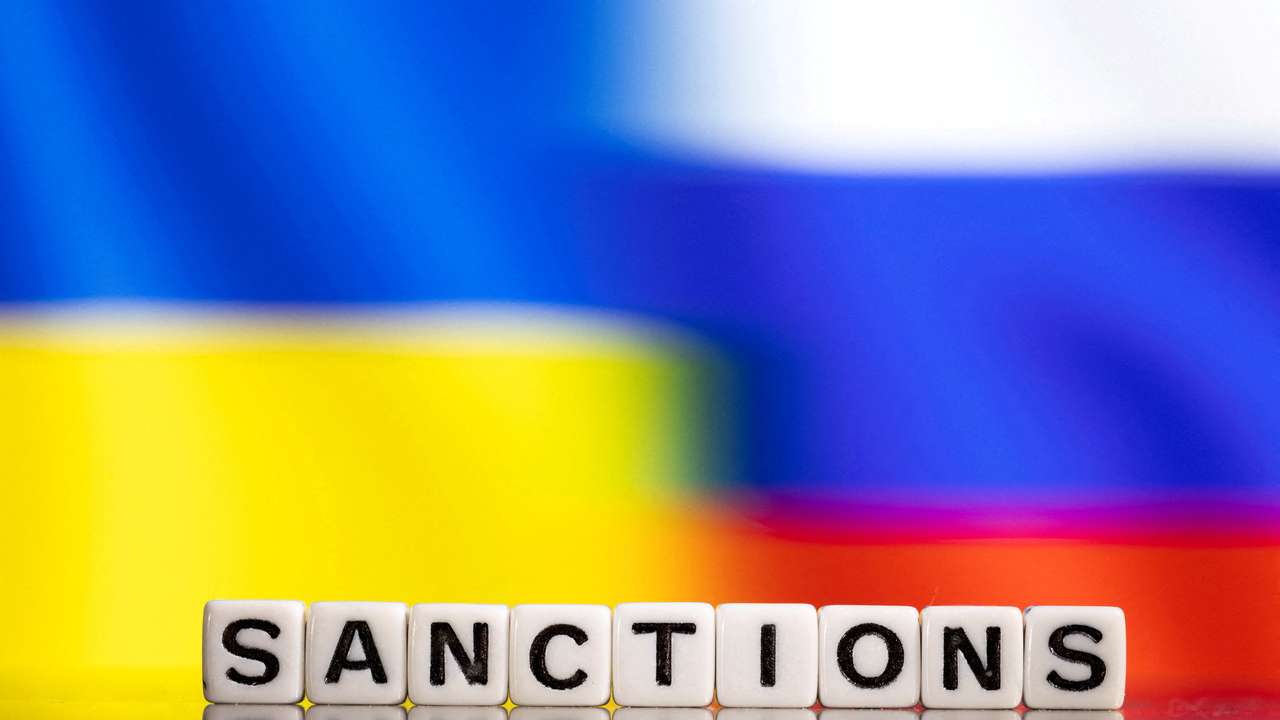 FILE PHOTO: Illustration shows letters arranged to read "Sanctions"  in front of Ukraine's and Russia's flag colors