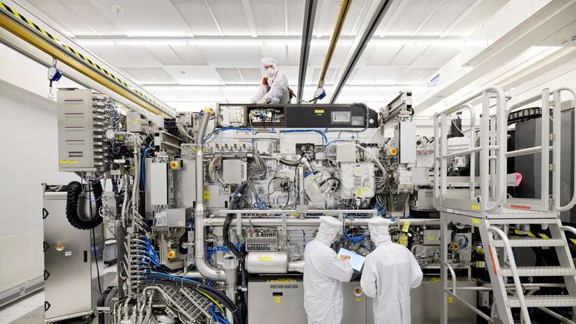 FILE PHOTO: Employees are seen working on the final assembly of ASML's TWINSCAN NXE:3400B semiconductor lithography tool with its panels removed, in Veldhoven