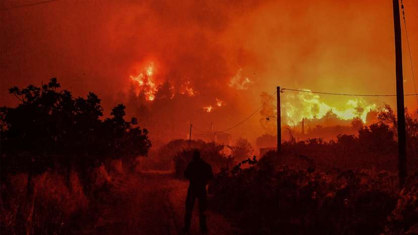 Wildfire burns next to the village of Ano Loutro, near Corinth