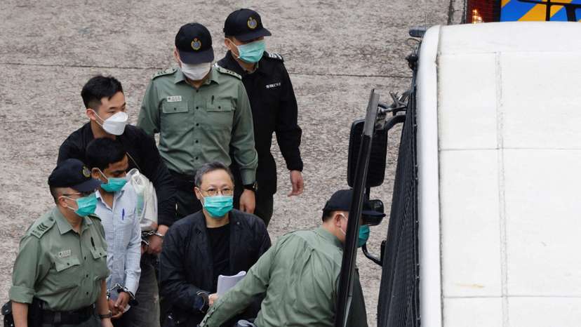 FILE PHOTO: Pro-democracy activist Benny Tai walks to a prison van to head to court over the national security law charge, in the early morning, in Hong Kong