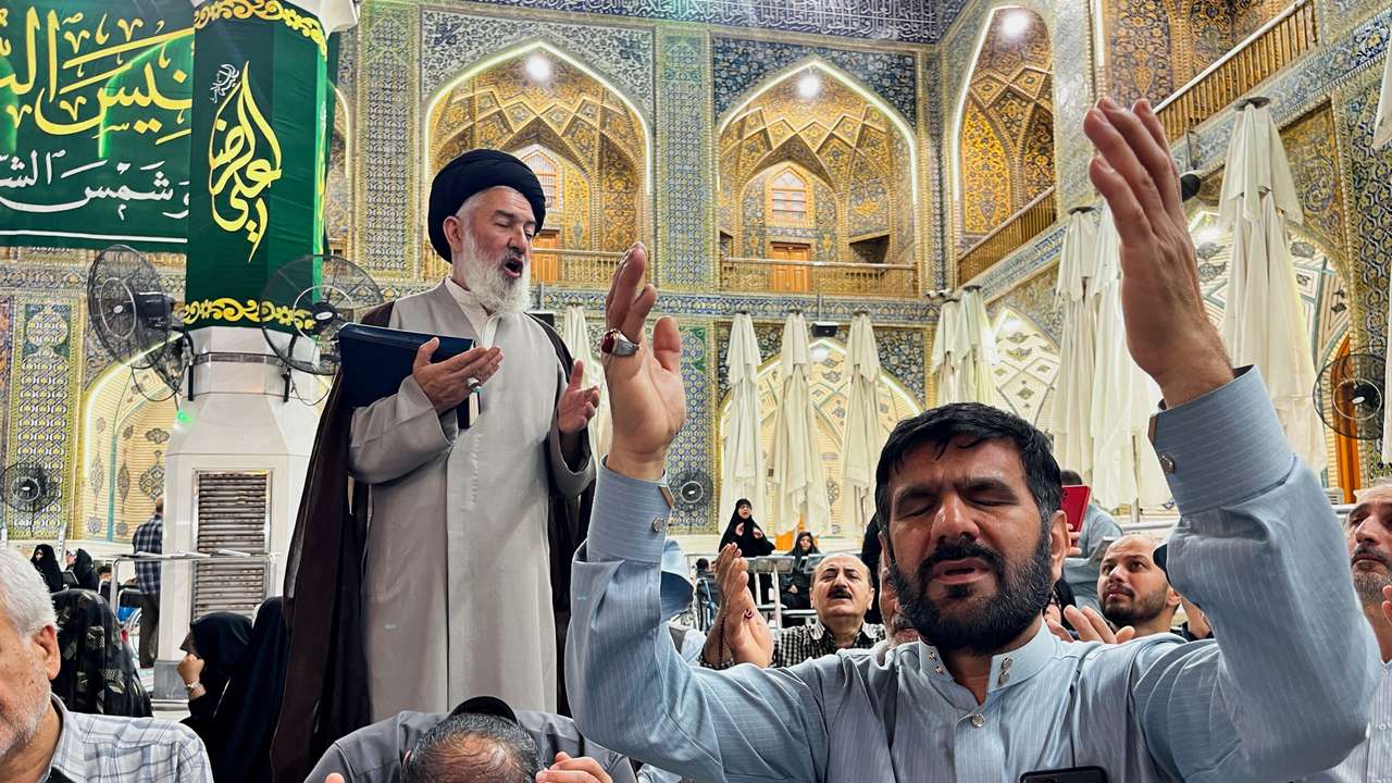 Iranian Shi'ite pilgrims pray for Iran's President Ebrahim Raisi following the crash of a helicopter carrying him, in Najaf