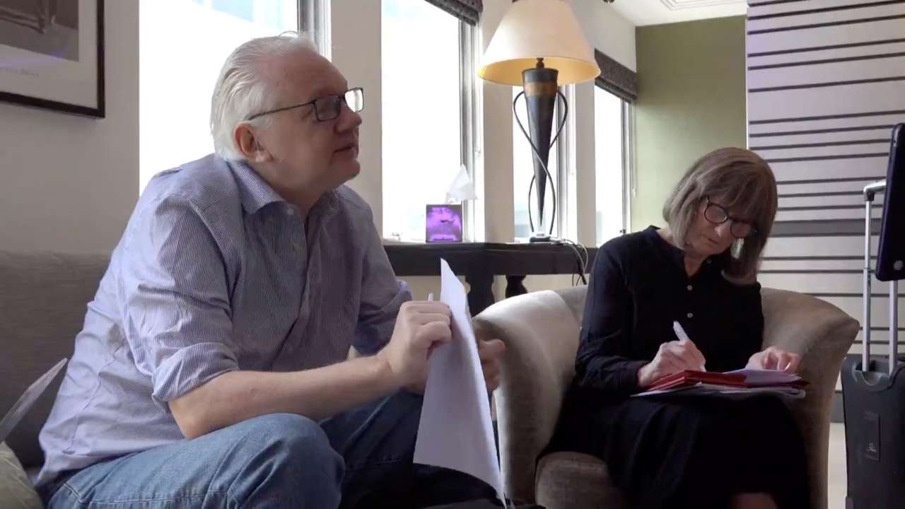 WikiLeaks founder Julian Assange holds a document at a location given as London
