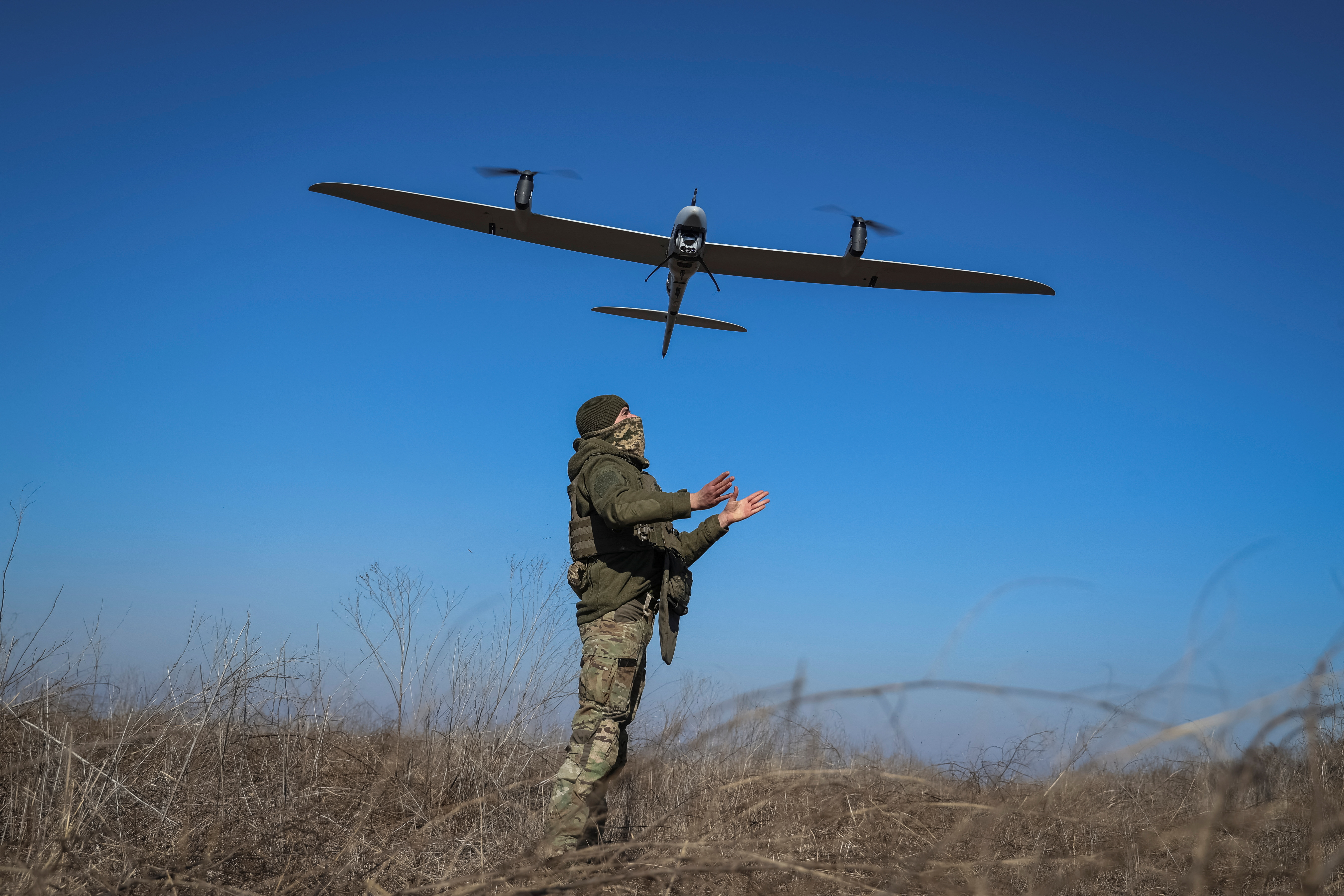 FILE PHOTO: A Ukrainian serviceman launches a mid-range reconnaissance drone type Vector for flying over positions of Russian troops near the town of Bakhmut