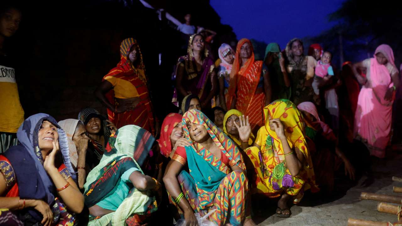 FILE PHOTO: Relatives mourn the death of stampede victims in Daunkeli, Hathras