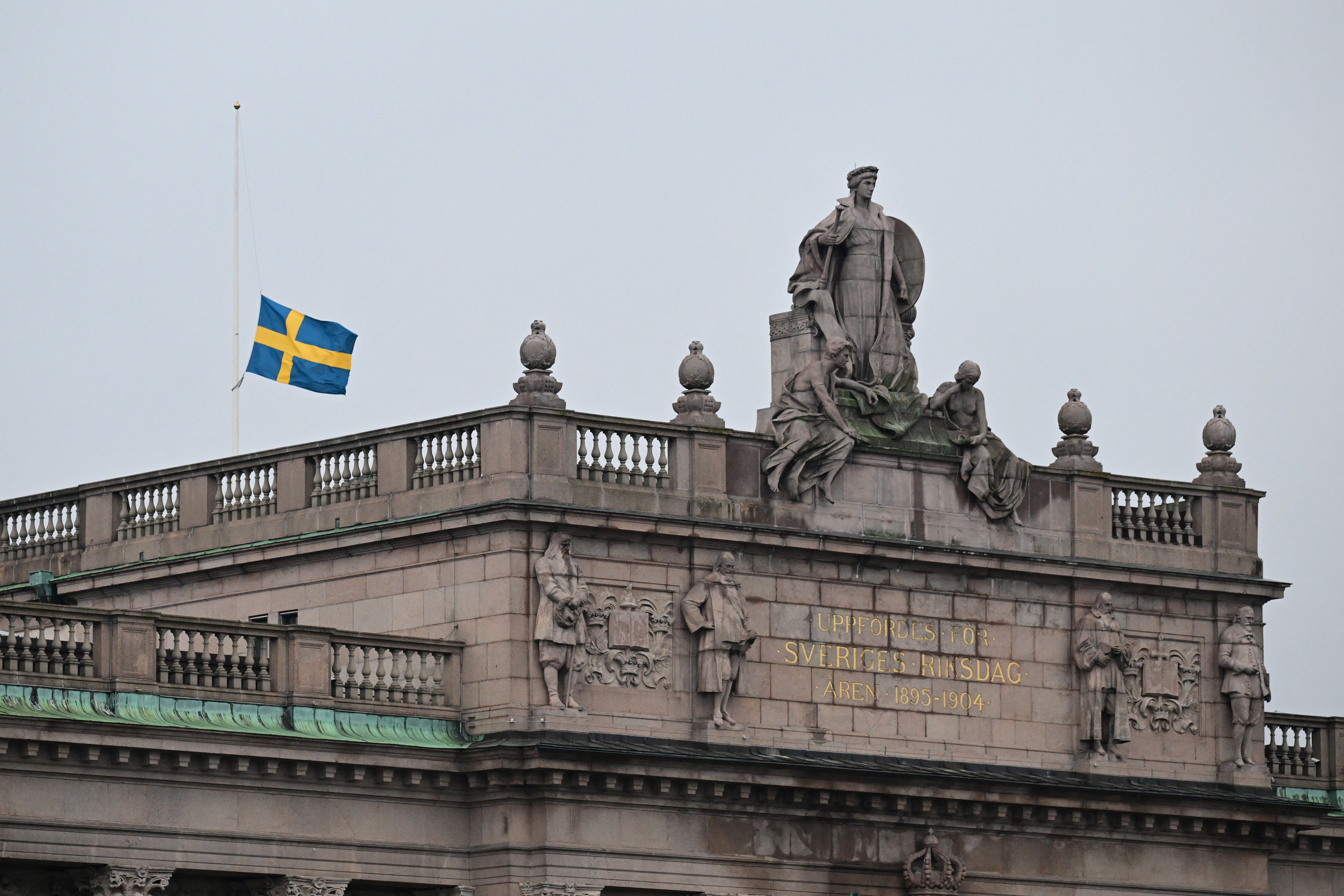 Swedish flag flies at half-mast, following yesterday's school shooting in Orebro, at the Swedish Parliament in Stockholm