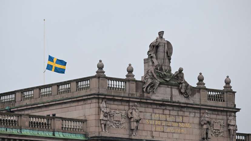 Swedish flag flies at half-mast, following yesterday's school shooting in Orebro, at the Swedish Parliament in Stockholm