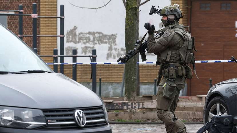 A police member works at the Clemenceau metro station, after a shooting took place in Brussels