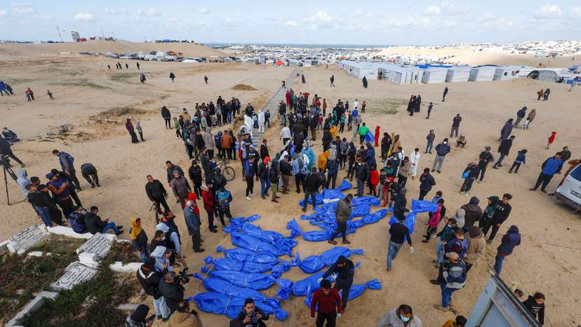 People bury Palestinians, including those who were killed in Israeli strikes and fire, after their bodies were released by Israel, in Rafah
