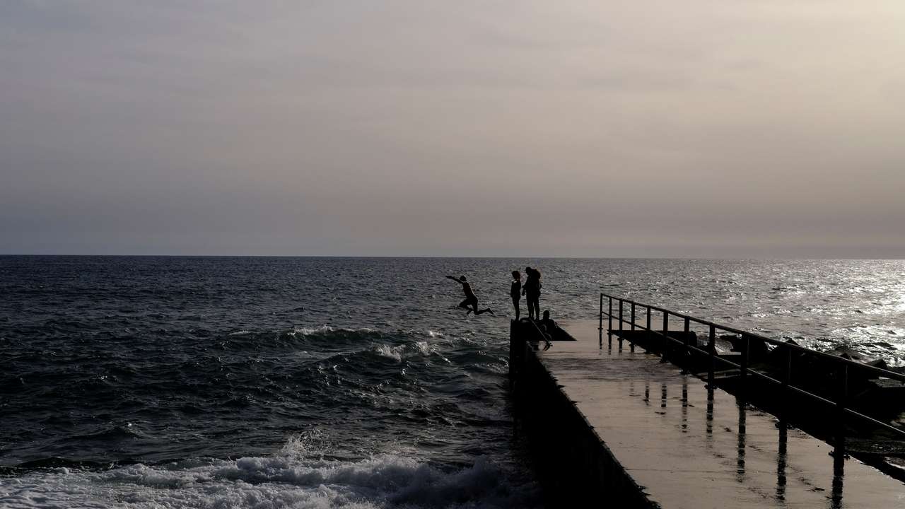 Pierre from Belgium, jumps into the Atlantic Ocean at Jardim do Mar on the Portuguese island of Madeira