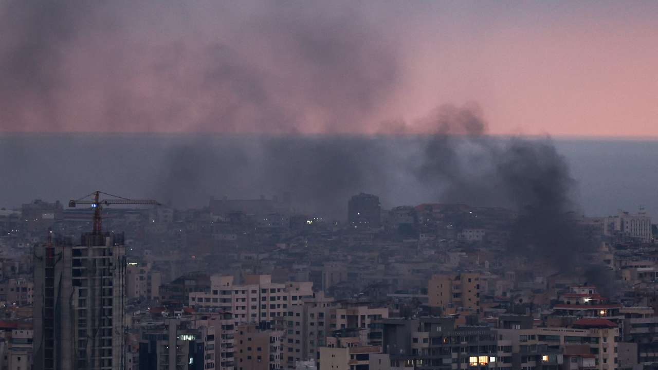 Smoke rises in Beirut's southern suburbs during sunset, after Israeli air strikes, amid ongoing hostilities between Hezbollah and Israeli forces, as seen from Sin El Fil