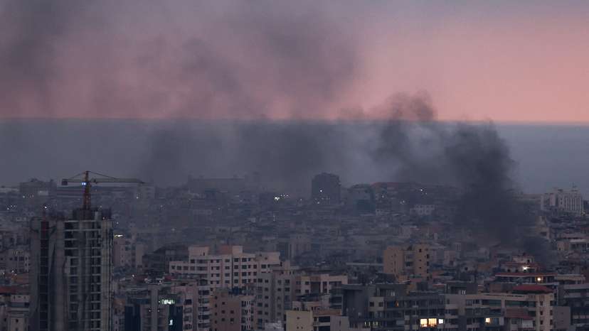 Smoke rises in Beirut's southern suburbs during sunset, after Israeli air strikes, amid ongoing hostilities between Hezbollah and Israeli forces, as seen from Sin El Fil