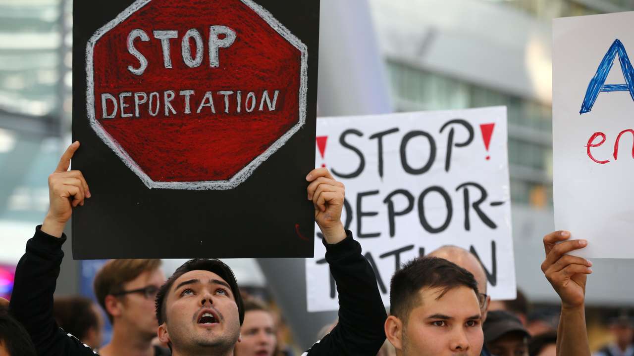 People protest against the German government's decision to deport migrants who were denied asylum, at Duesseldorf Airport
