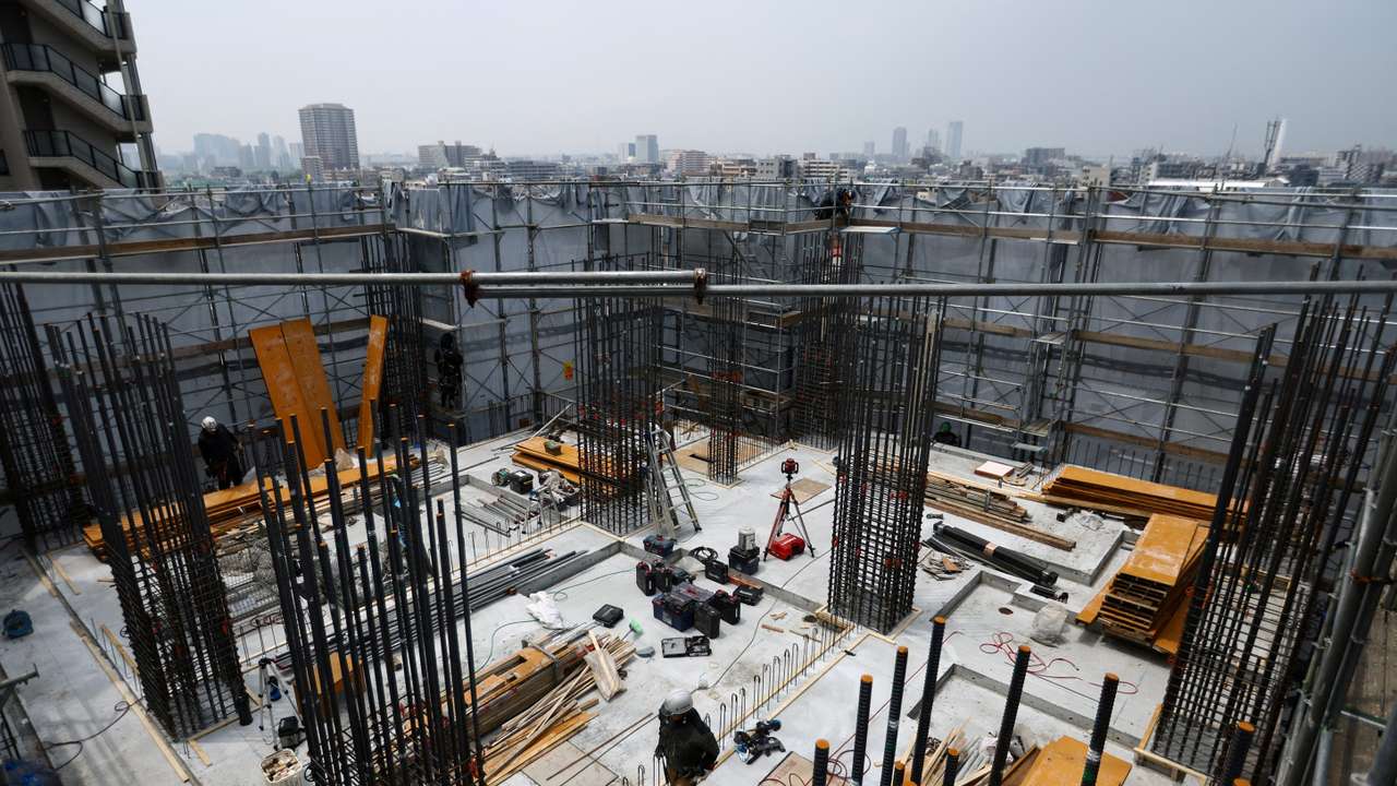 Heat-exposed workers, are seen at the top of an apartment building under-construction, as the Japanese government issued a heatstroke alert, in Tokyo