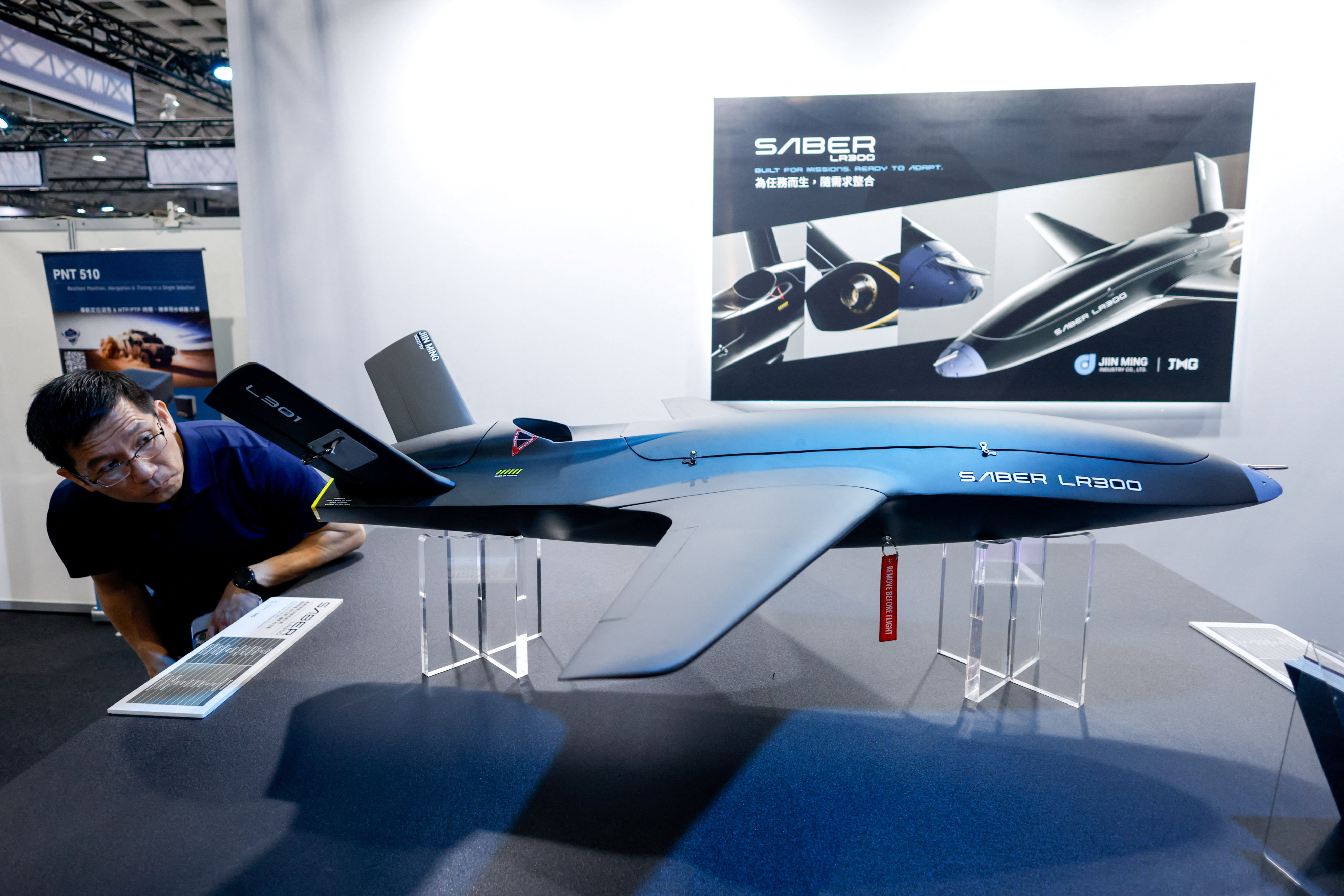 A visitor looks at a model of the Saber LR300 unmanned aerial vehicle, developed by Taiwan’s Jiin Ming Industry,  in Taipei