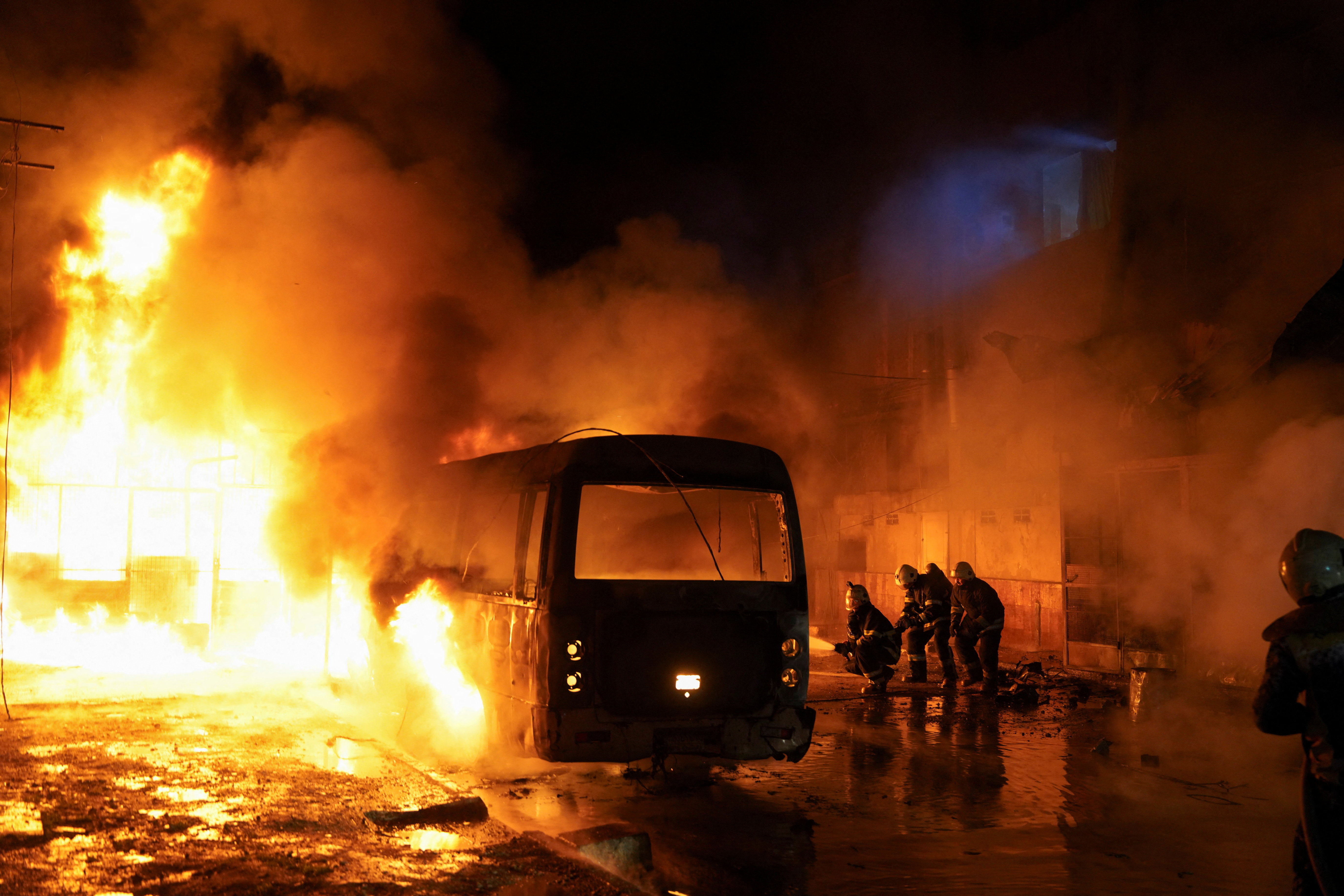 Members of the Syrian Civil Defence work to extinguish a fire that broke out following shelling