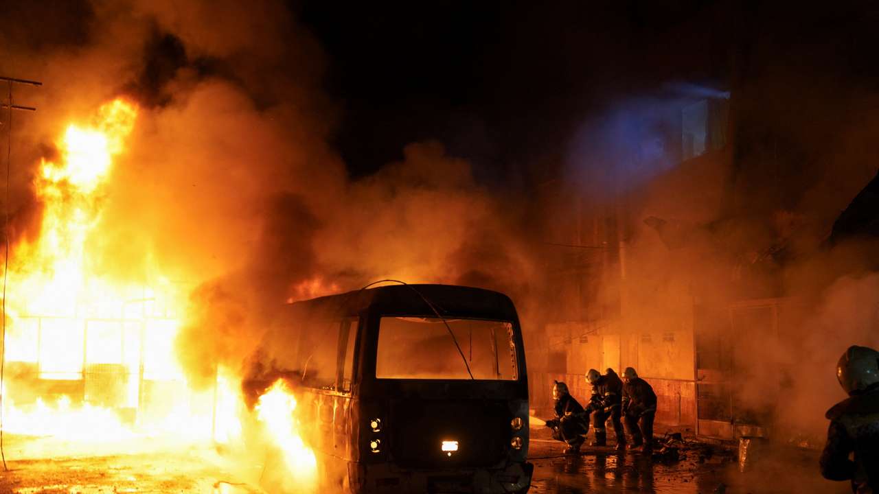 Members of the Syrian Civil Defence work to extinguish a fire that broke out following shelling