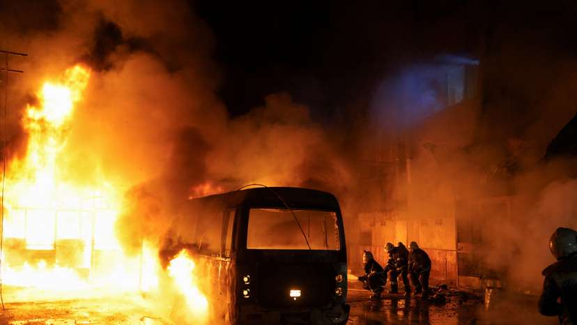 Members of the Syrian Civil Defence work to extinguish a fire that broke out following shelling