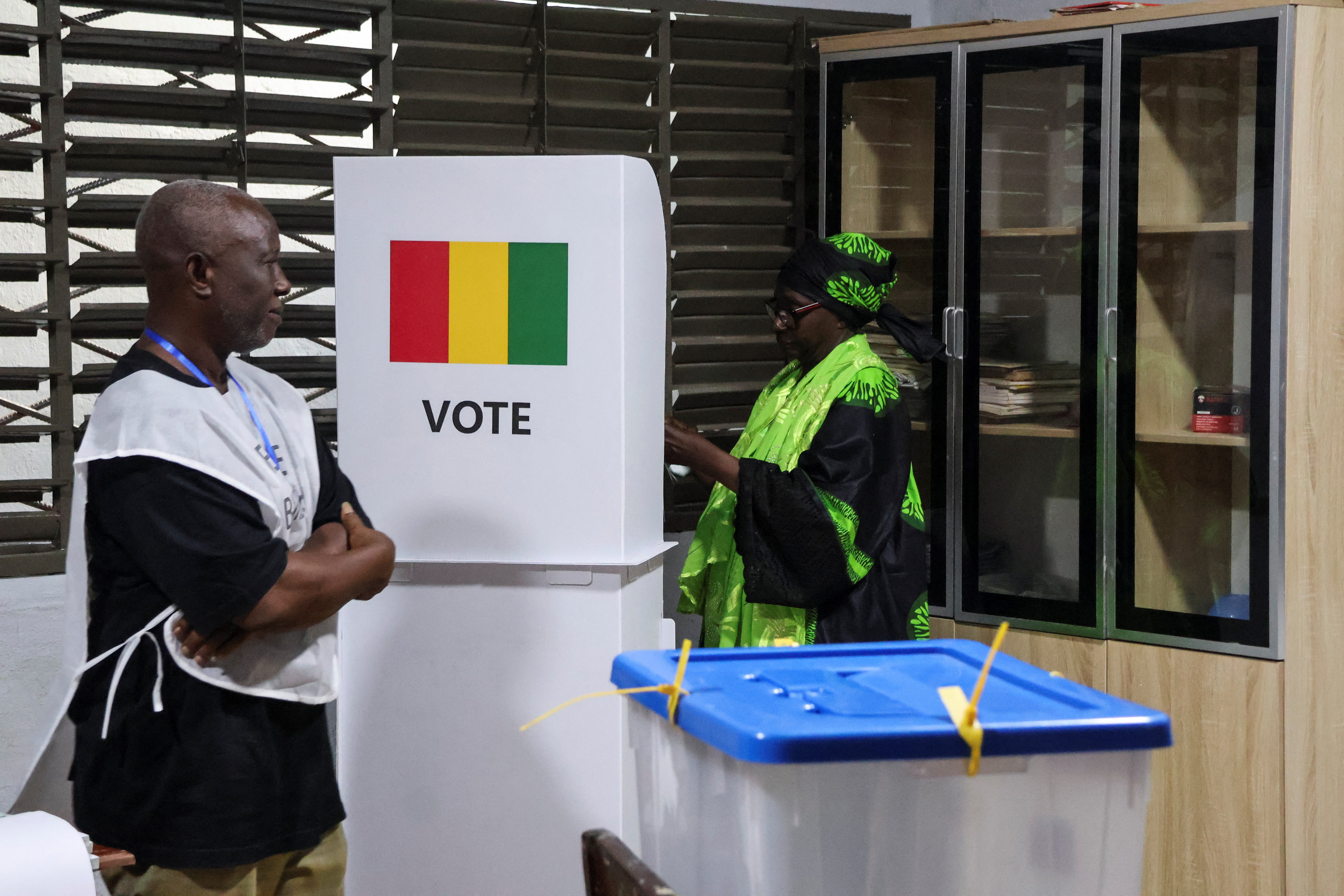 A woman prepares to cast her vote during the presidential election at a polling station in Conakry, Guinea December 28, 2025. REUTERS/ Souleymane Camara