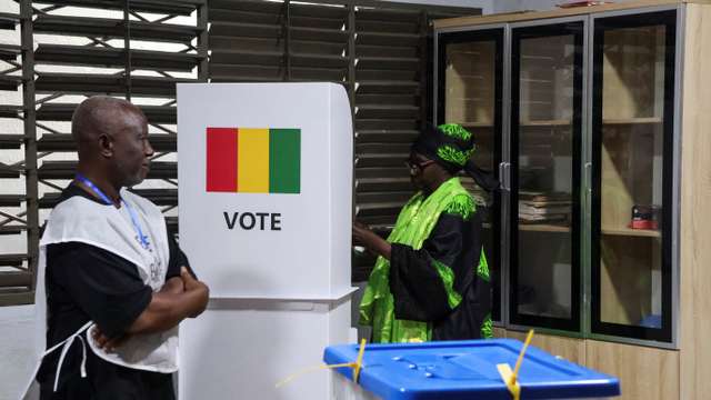 A woman prepares to cast her vote during the presidential election at a polling station in Conakry, Guinea December 28, 2025. REUTERS/ Souleymane Camara