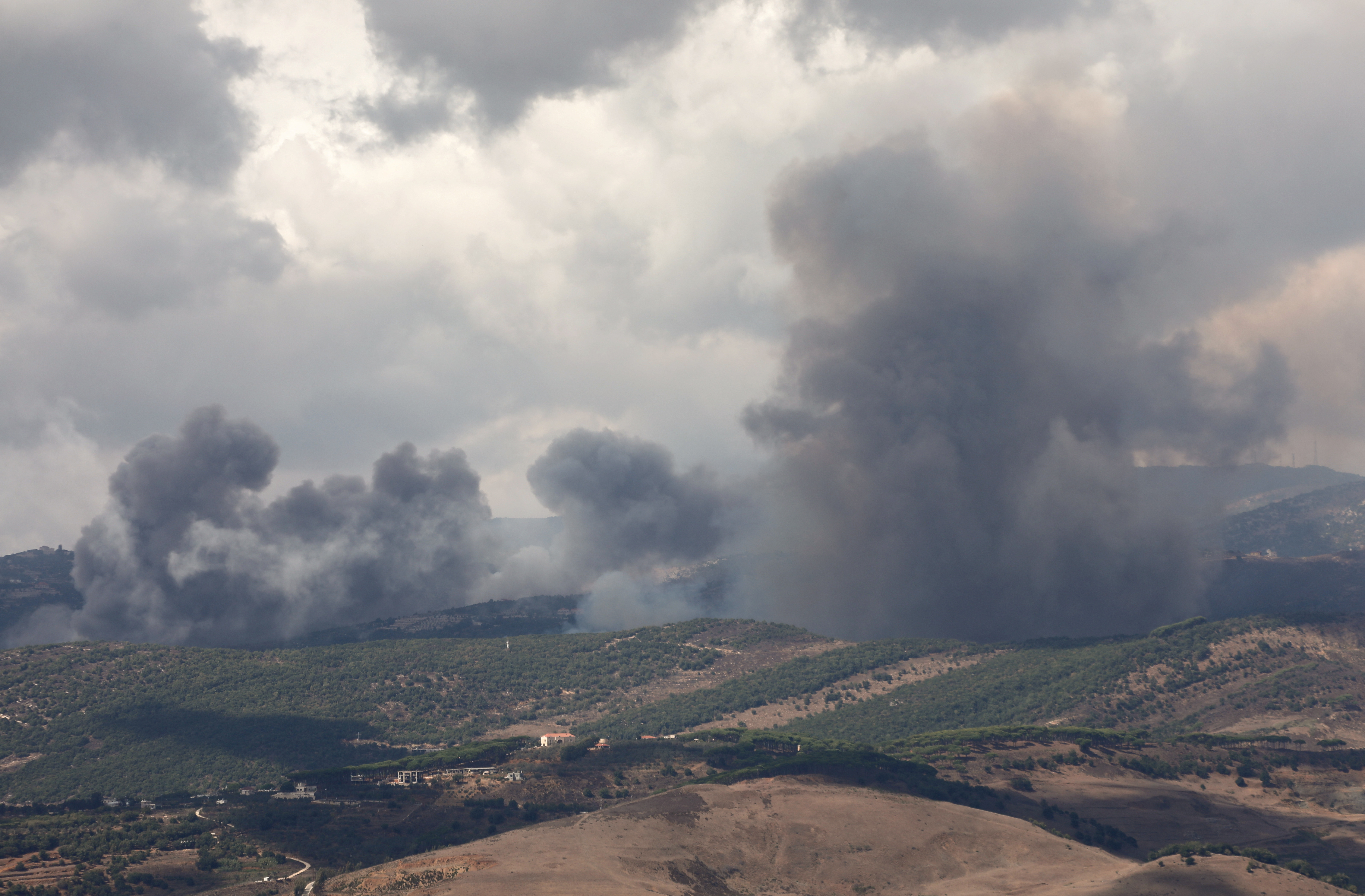 Smoke rises from Jabal al-Rihan as pictured from Marjayoun