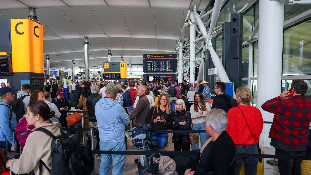Travellers at Heathrow Airport amid cyberattack disruptions, in Greater London