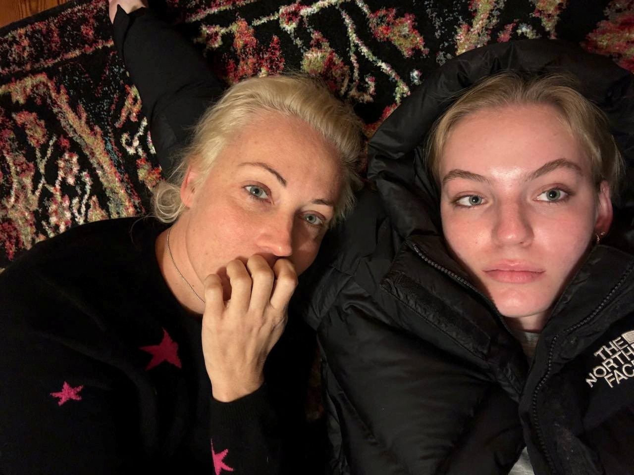 Yulia Navalnaya, the widow of Alexei Navalny, lies down with her daughter Dasha Navalnaya