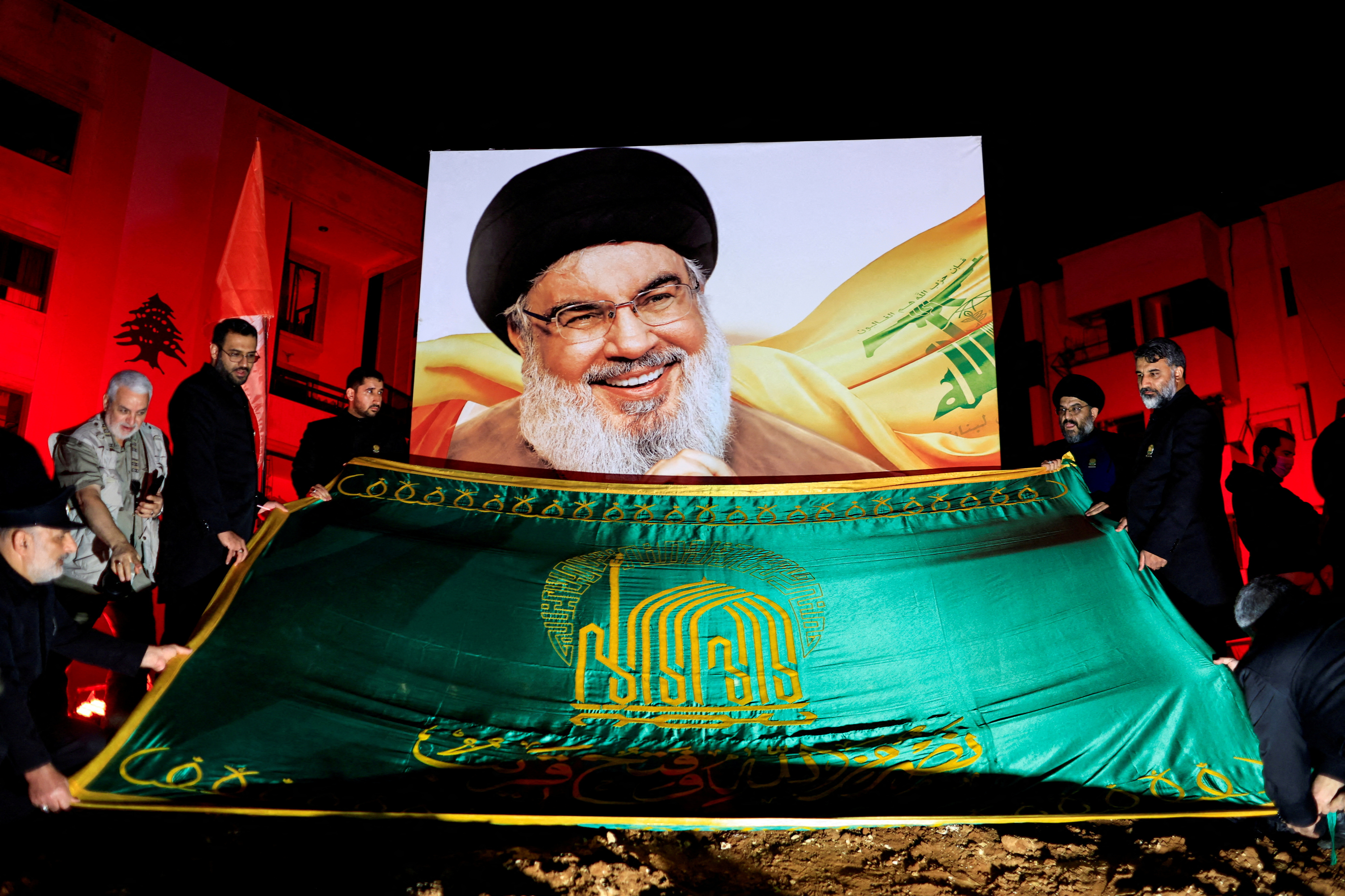 FILE PHOTO: People gather at a site damaged by Israeli airstrike that killed Lebanon's Hezbollah leader Sayyed Hassan Nasrallah, in Beirut