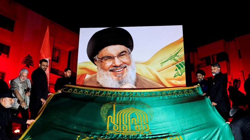 FILE PHOTO: People gather at a site damaged by Israeli airstrike that killed Lebanon's Hezbollah leader Sayyed Hassan Nasrallah, in Beirut