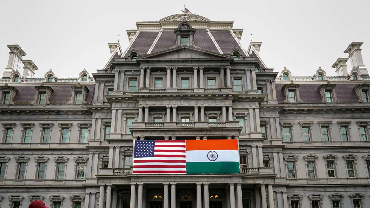 The flags of the United States and India on the Eisenhower Executive Office Building at the White House in Washington