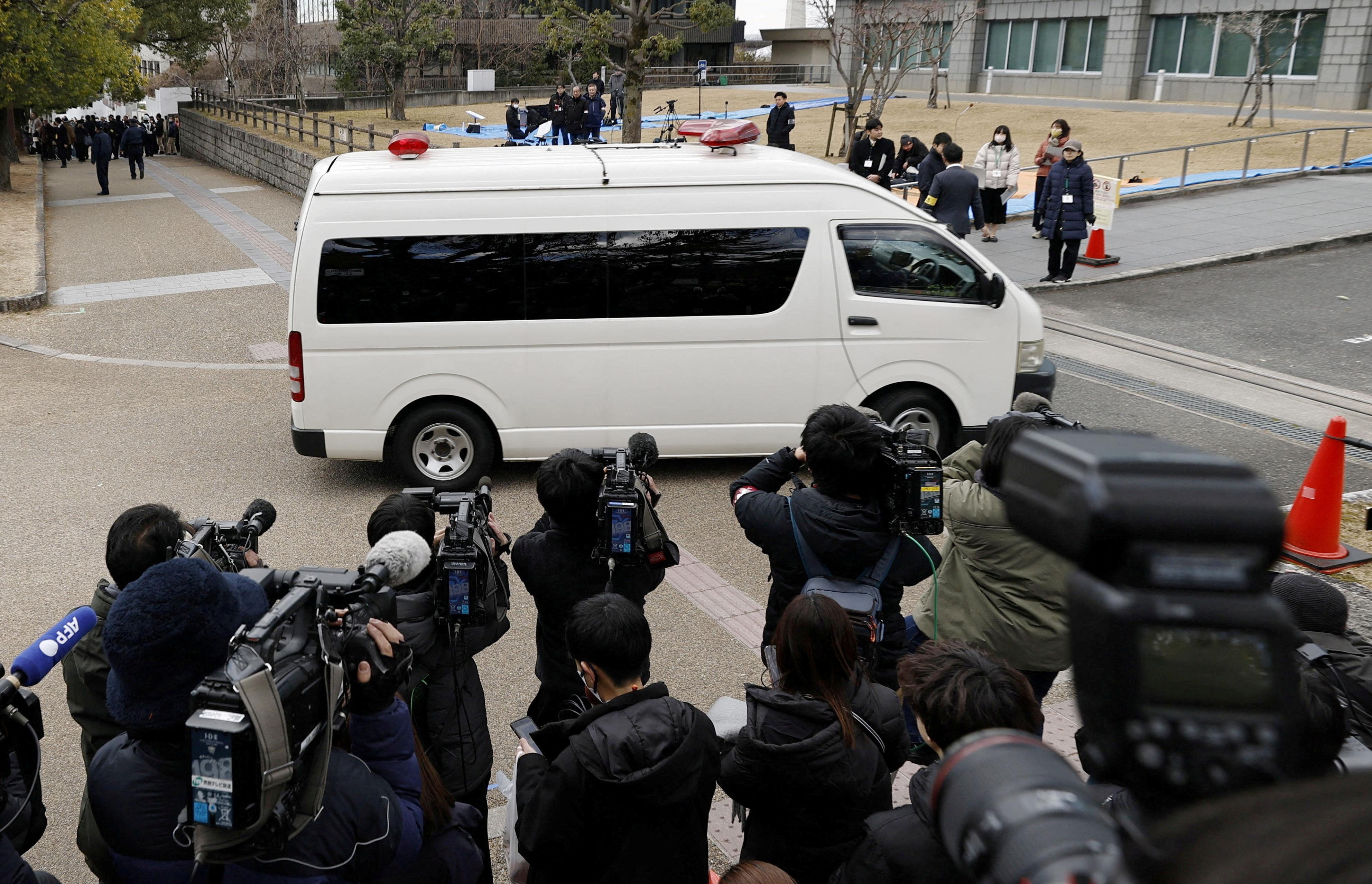 A vehicle carrying Tetsuya Yamagami, who is accused of fatally shooting former Prime Minister Shinzo Abe, enters the Nara District Court in Nara
