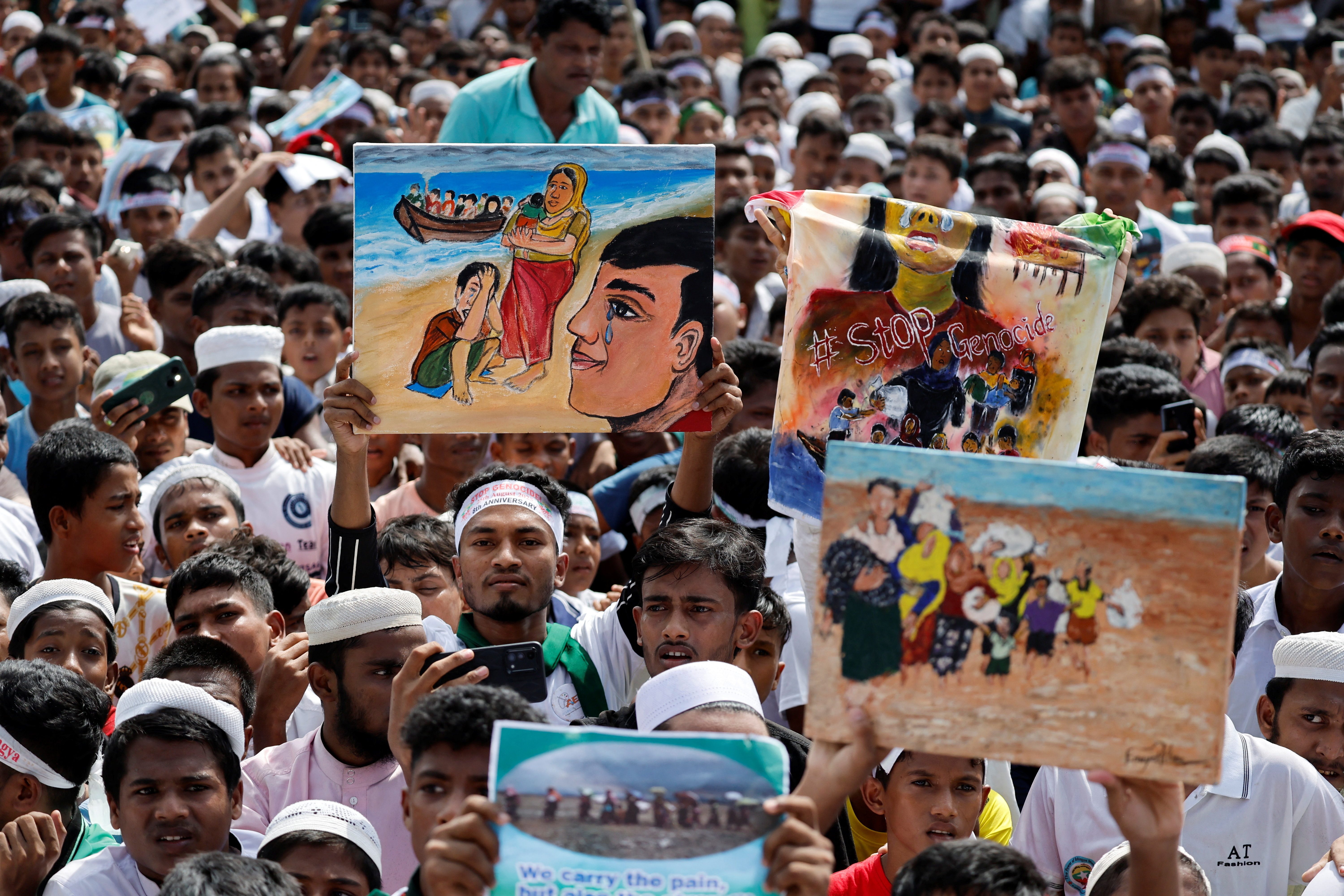 Rohingya refugees take part in a rally to mark the eight-year anniversary of their exodus, in Cox's Bazar