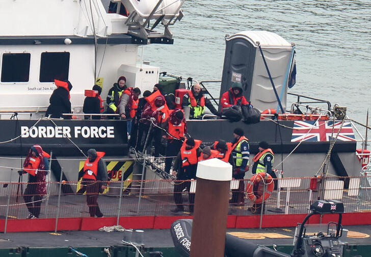 FILE PHOTO: People, believed to be migrants, arrive at Port of Dover, Dover
