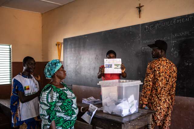 An electoral official displays a ballot during vote counting at a polling station in Porto-Novo, on April 12, 2026 during Benin's presidential elections. (Photo by OLYMPIA DE MAISMONT / AFP)