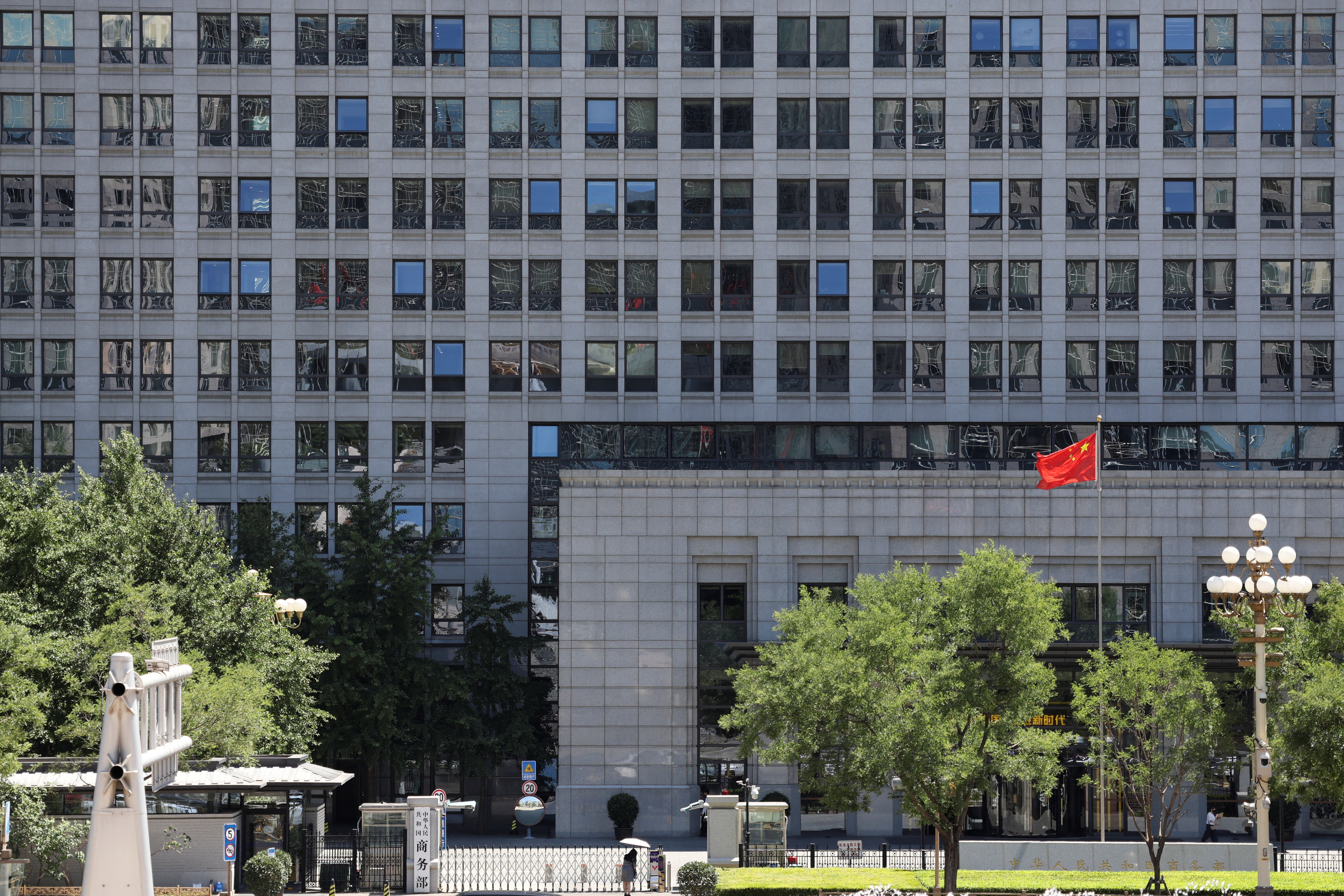 FILE PHOTO: A Chinese flag flutters at the Chinese Ministry of Commerce building in Beijing