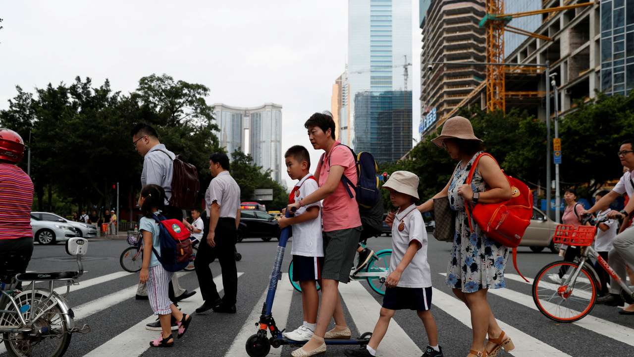 FILE PHOTO: Children and their parents are seen on their way to the school in Tianhe district in Guanghzou