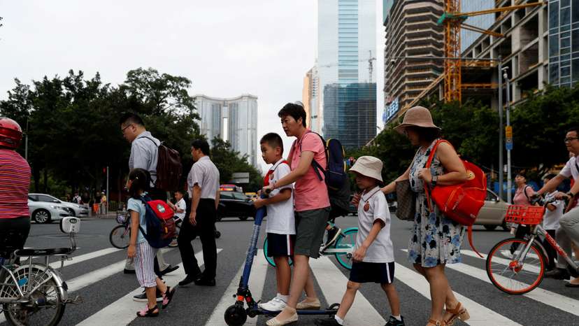 FILE PHOTO: Children and their parents are seen on their way to the school in Tianhe district in Guanghzou