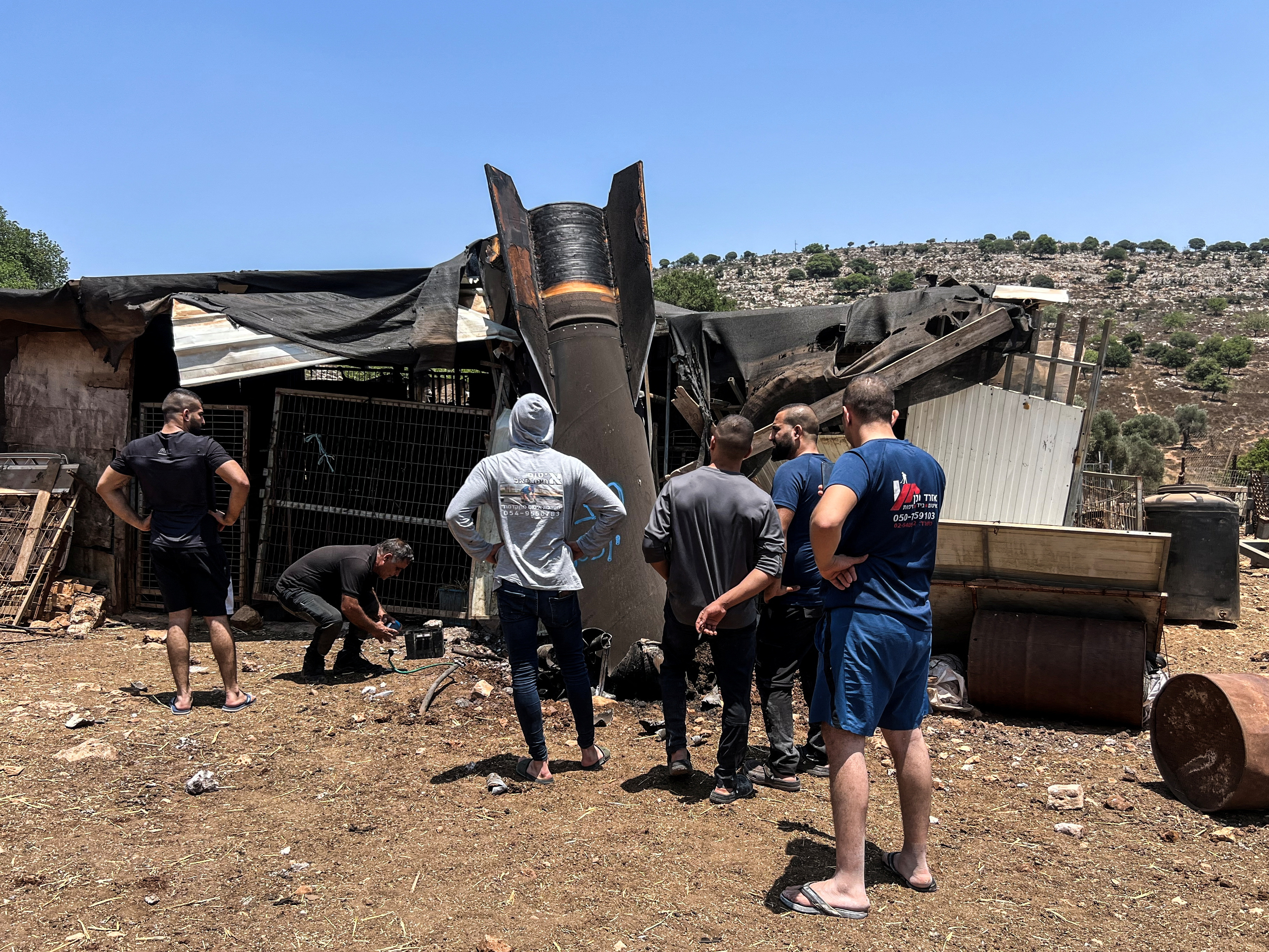 People look at an apparent remains of a ballistic missile following missile attack by Iran on Israel earlier today, in northern Israel