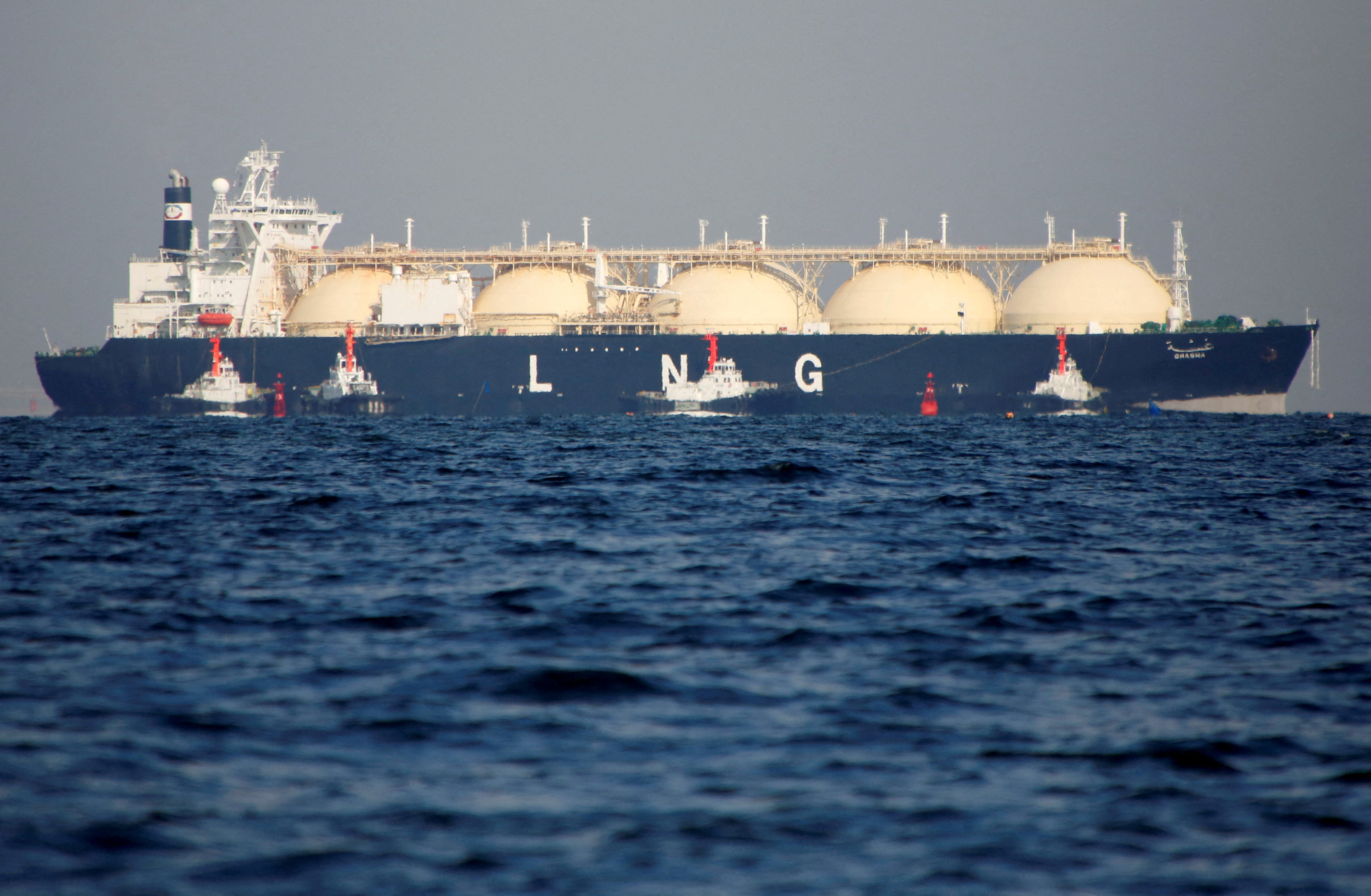 FILE PHOTO: FILE PHOTO: A LNG tanker is tugged towards a thermal power station in Futtsu