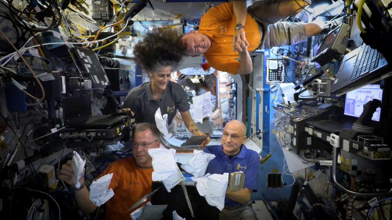FILE PHOTO: NASA astronauts on ISS unbox Thanksgiving meals in space