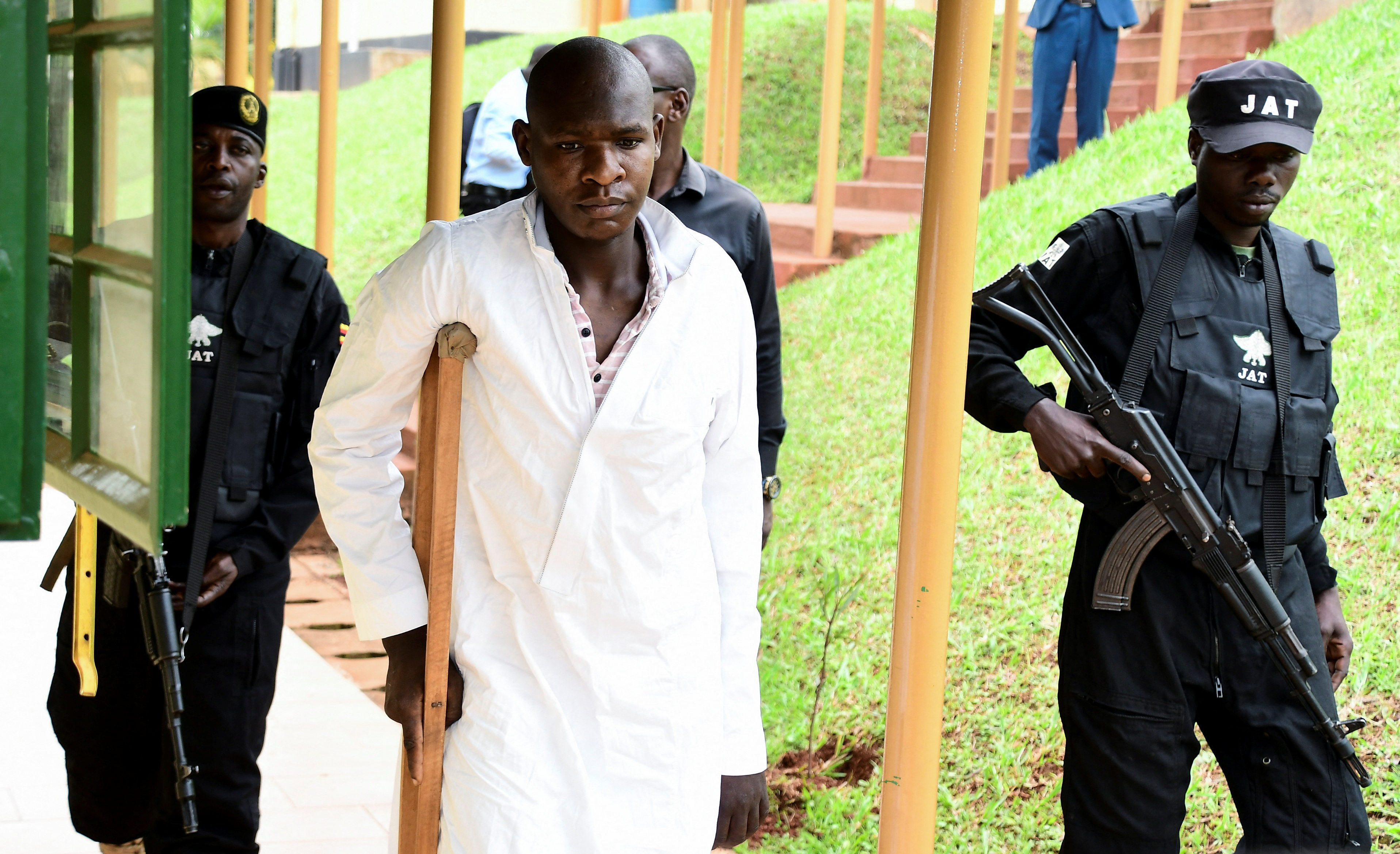 Kyoto Abdul Rashid a commander of the ADF is escorted as he arrives at the Chief Magistrate Court in Nakawa division of Kampala
