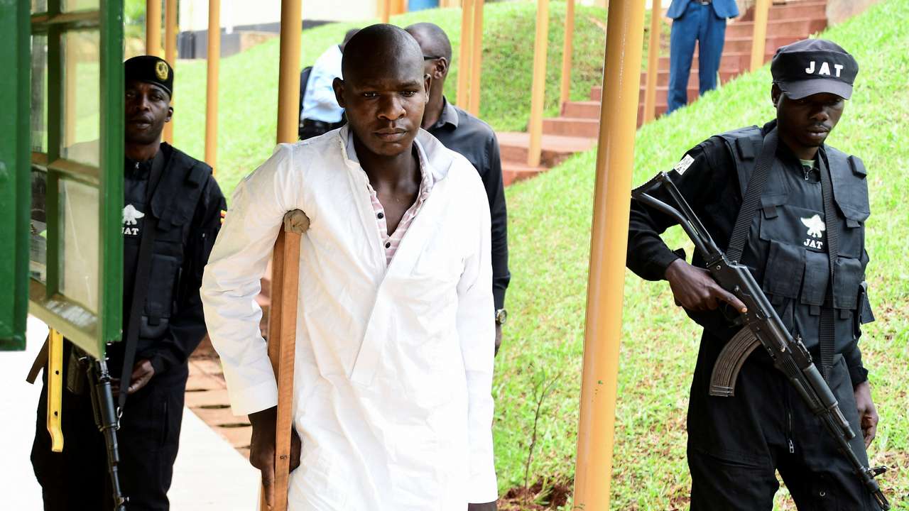 Kyoto Abdul Rashid a commander of the ADF is escorted as he arrives at the Chief Magistrate Court in Nakawa division of Kampala