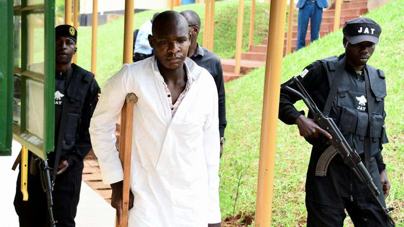 Kyoto Abdul Rashid a commander of the ADF is escorted as he arrives at the Chief Magistrate Court in Nakawa division of Kampala