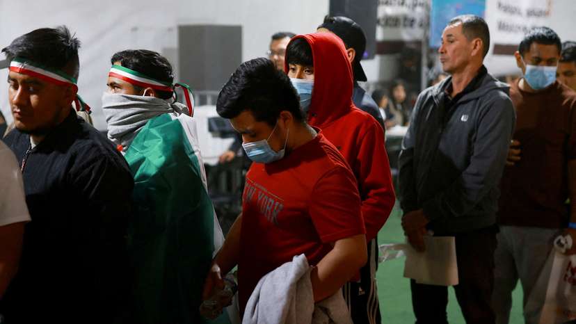 FILE PHOTO: Mexican migrants deported from U.S. stand in a temporary shelter in Ciudad Juarez