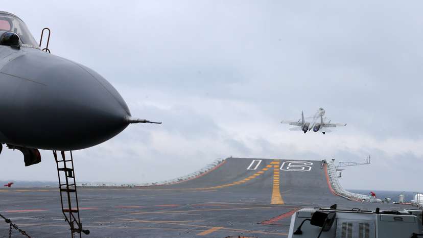 J-15 fighters from China's Liaoning aircraft carrier conduct a drill in an area of South China Sea
