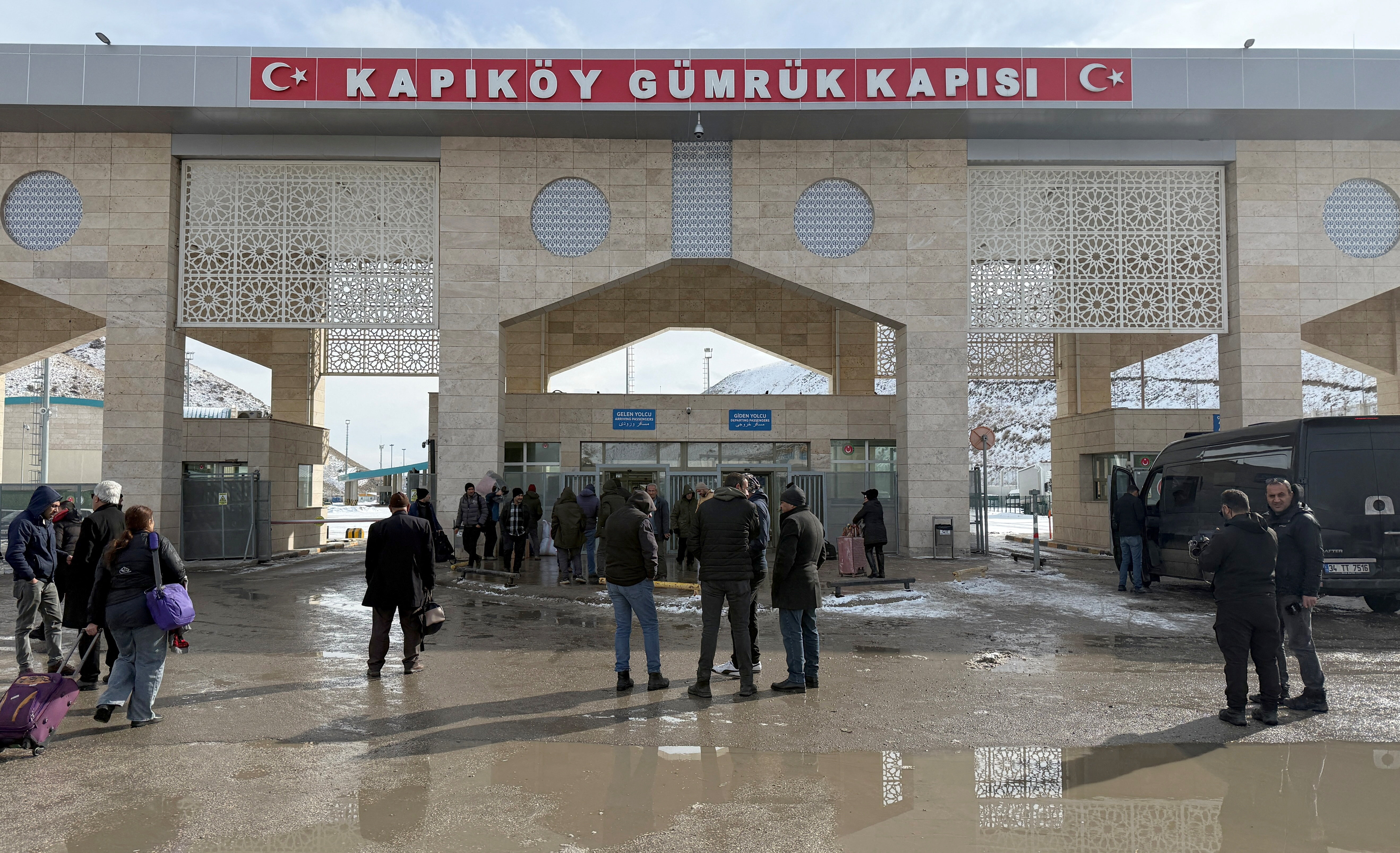 People stand at the Kapikoy Border Gate, between Turkey and Iran, in Van province